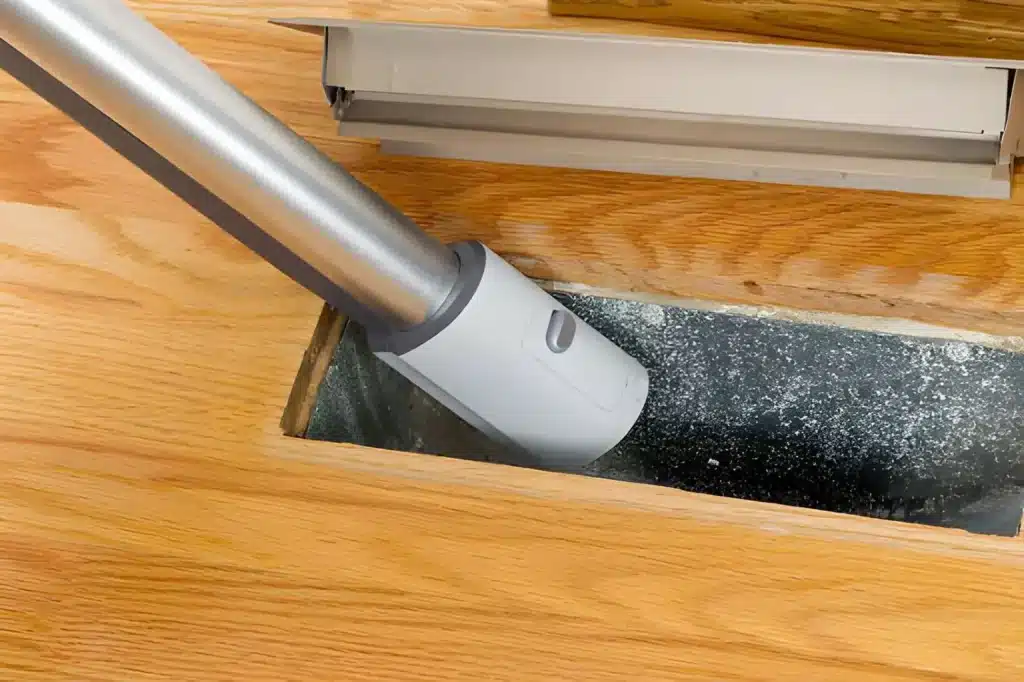 Expert performing Duct Cleaning service inside a home's HVAC ventilation system.